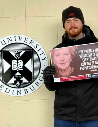 TPUK activist holding a Margaret Thatcher quote poster at the University of Edinburgh.