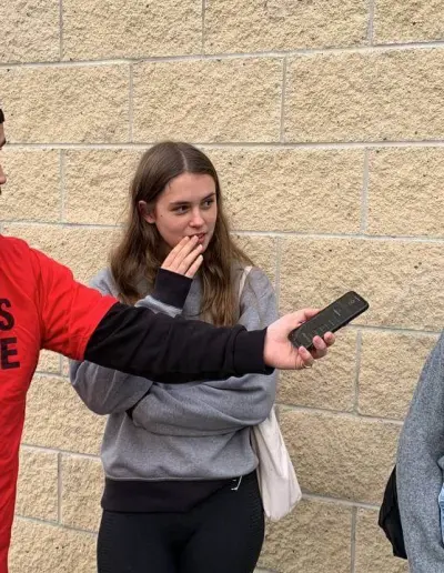 Woman being interviewed outdoors at a Turning Point UK event.