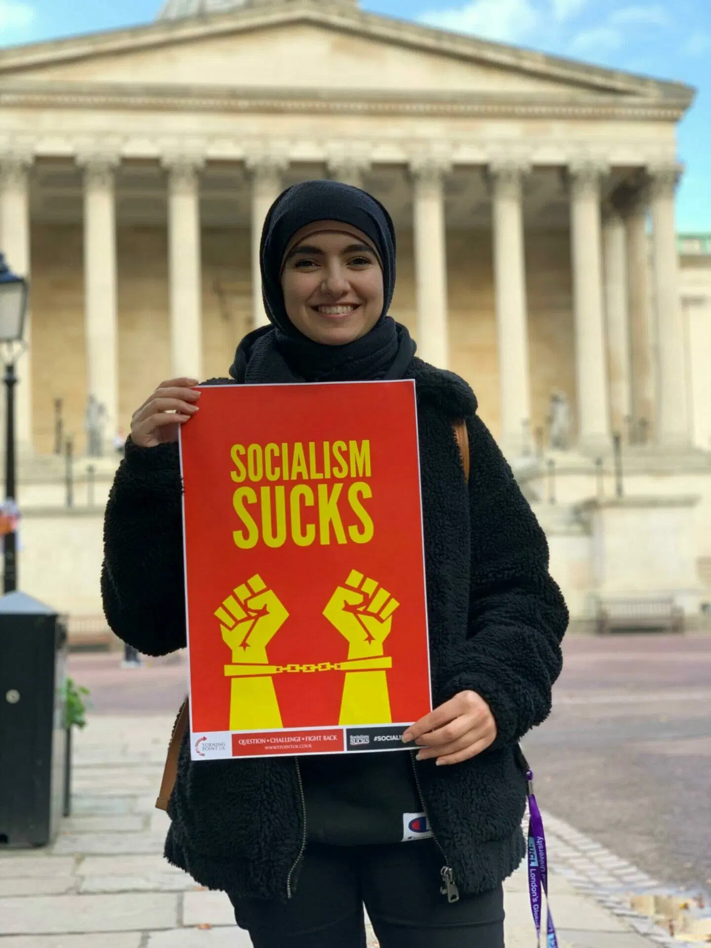 Activist engaging with students outside a London university campus.